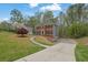 Traditional brick home with manicured front lawn, mature trees, and inviting curb appeal at 4495 Sagebrush Nw Dr, Kennesaw, GA 30152