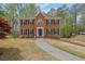 Two-story brick home with a landscaped front yard and charming walkway to the entrance at 4495 Sagebrush Nw Dr, Kennesaw, GA 30152