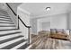 Welcoming foyer with hardwood floors, staircase, and a view of the living room at 4495 Sagebrush Nw Dr, Kennesaw, GA 30152