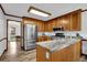 Kitchen area with stainless steel appliances, wood cabinets, and granite countertops at 4495 Sagebrush Nw Dr, Kennesaw, GA 30152