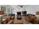 Spacious living room featuring a fireplace and neutral decor with lots of natural lighting at 4495 Sagebrush Nw Dr, Kennesaw, GA 30152