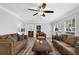 Inviting living room featuring wood-look floors, neutral paint, ceiling fan, and modern furnishings at 4495 Sagebrush Nw Dr, Kennesaw, GA 30152