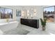 Luxurious bathroom with a freestanding tub, marble flooring, double vanity, and bright natural light at 478 Majestic Oaks Pl, Smyrna, GA 30082