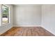 Comfortable bedroom with hardwood floors, a window with natural light, and neutral paint at 478 Majestic Oaks Pl, Smyrna, GA 30082