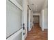Bright hallway featuring hardwood floors, sliding doors, and white trim at 478 Majestic Oaks Pl, Smyrna, GA 30082
