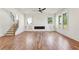 Spacious living room with fireplace, hardwood floors, staircase, and large windows at 478 Majestic Oaks Pl, Smyrna, GA 30082