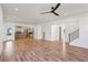 Open-concept living room with hardwood floors, staircase, kitchen, and modern design at 478 Majestic Oaks Pl, Smyrna, GA 30082