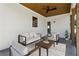 Covered patio featuring a cozy seating arrangement with a rug, couch, and two chairs at 478 Majestic Oaks Pl, Smyrna, GA 30082