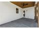 Covered patio with stained wood ceiling, fan, white siding, and concrete flooring at 478 Majestic Oaks Pl, Smyrna, GA 30082