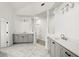 Bathroom with double vanities, gray cabinets, white countertops, and marble floors at 636 Ginger Cake Rd, Fayetteville, GA 30214