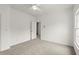 Bedroom with neutral carpet, ceiling fan, and an open doorway at 636 Ginger Cake Rd, Fayetteville, GA 30214
