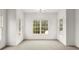 Bedroom features neutral carpet, a modern light fixture, and three large windows at 636 Ginger Cake Rd, Fayetteville, GA 30214