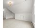 Bedroom with angled ceiling, neutral carpet, and a modern light fixture at 636 Ginger Cake Rd, Fayetteville, GA 30214