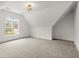 Angled ceiling bedroom with vaulted window and neutral carpet at 636 Ginger Cake Rd, Fayetteville, GA 30214