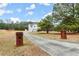 A long driveway leads to a charming two-story home with large yard at 636 Ginger Cake Rd, Fayetteville, GA 30214