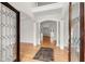 Grand foyer with soaring ceilings, elegant columns, hardwood floors, and arched doorways at 636 Ginger Cake Rd, Fayetteville, GA 30214