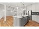 Open concept kitchen features a center island, stainless appliances, and seamless flow to living area at 636 Ginger Cake Rd, Fayetteville, GA 30214