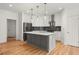 Bright kitchen features a large island, stainless steel appliances, and modern pendant lighting at 636 Ginger Cake Rd, Fayetteville, GA 30214