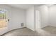 Bright room features a door leading outside and a view into another room, all with neutral carpeting at 636 Ginger Cake Rd, Fayetteville, GA 30214