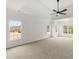 Bright main bedroom boasts a tray ceiling, ceiling fan, neutral carpet, and multiple windows at 636 Ginger Cake Rd, Fayetteville, GA 30214