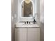 Chic powder room features a marble countertop, unique mirror, and modern faucet at 1035 Walker Se Ave, Atlanta, GA 30316
