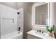 Contemporary bathroom featuring a stylish vanity, shower with elegant tile, and an illuminated mirror at 1035 Walker Se Ave, Atlanta, GA 30316