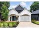 Charming home featuring modern design, a geometric accent wall, lush landscaping, and a welcoming driveway at 1035 Walker Se Ave, Atlanta, GA 30316