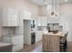 Contemporary kitchen featuring high gloss cabinets, stainless appliances and a wooden island with marble countertops at 1035 Walker Se Ave, Atlanta, GA 30316