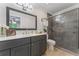 Updated bathroom featuring a gray vanity with quartz countertop and a glass enclosed tiled shower at 1088 Riverbend Club Se Dr, Atlanta, GA 30339