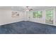 Bedroom featuring blue carpet, ceiling fan, and natural light coming through windows at 1088 Riverbend Club Se Dr, Atlanta, GA 30339