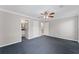 Bedroom with blue carpet with an entrance into the bathroom and staircase at 1088 Riverbend Club Se Dr, Atlanta, GA 30339