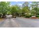 Gated community entrance with lush landscaping and signage at 1088 Riverbend Club Se Dr, Atlanta, GA 30339