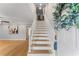 Welcoming foyer with wood stairs, an overhead skylight, and open living space at 1088 Riverbend Club Se Dr, Atlanta, GA 30339