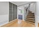 Hallway with wood floors, storage cabinets, and a staircase leading to the second floor at 1088 Riverbend Club Se Dr, Atlanta, GA 30339