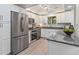 Modern kitchen with white cabinets, stainless steel appliances, and breakfast bar at 1088 Riverbend Club Se Dr, Atlanta, GA 30339