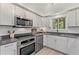 Modern kitchen with white cabinets, stainless steel appliances, and ample counter space at 1088 Riverbend Club Se Dr, Atlanta, GA 30339