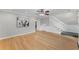 Open-concept living area with hardwood floors and staircase access at 1088 Riverbend Club Se Dr, Atlanta, GA 30339