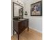 Stylish powder room with wainscoting, a dark vanity, and unique art at 1088 Riverbend Club Se Dr, Atlanta, GA 30339