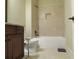 Bright bathroom featuring a bathtub with tile surround, toilet, and dark wood vanity at 118 Cedarcrest Village Ct, Acworth, GA 30101