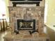 Close-up of a stone fireplace with a dark interior, flanked by decorative figures and a broom at 118 Cedarcrest Village Ct, Acworth, GA 30101