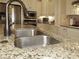 Close up of a kitchen featuring granite countertops and a stainless steel sink with bronze fixtures at 118 Cedarcrest Village Ct, Acworth, GA 30101