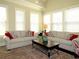 Bright living room filled with natural light, featuring comfortable seating, neutral walls, and a patterned rug at 118 Cedarcrest Village Ct, Acworth, GA 30101