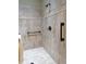 Walk-in shower with decorative tile accents and a handrail for accessibility at 118 Cedarcrest Village Ct, Acworth, GA 30101