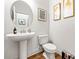 Modern bathroom with pedestal sink, updated fixtures, and decorative wall art at 2018 Manchester Ne St, Atlanta, GA 30324