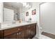 Bright bathroom featuring a double vanity with wood cabinets and a glass-enclosed shower at 2018 Manchester Ne St, Atlanta, GA 30324