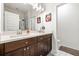 Bright bathroom featuring a double vanity with wood cabinets and a glass-enclosed shower at 2018 Manchester Ne St, Atlanta, GA 30324