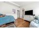 Bedroom with a bed, dresser with television, and natural light; adjacent to a bathroom at 2018 Manchester Ne St, Atlanta, GA 30324