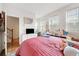 Bedroom with large windows, pink comforter, and a view of the staircase at 2018 Manchester Ne St, Atlanta, GA 30324
