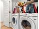 Laundry room featuring a washer and dryer with storage shelves and a door at 2018 Manchester Ne St, Atlanta, GA 30324