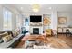 Bright living room featuring a cozy fireplace, stylish decor and large windows offering natural light at 2018 Manchester Ne St, Atlanta, GA 30324
